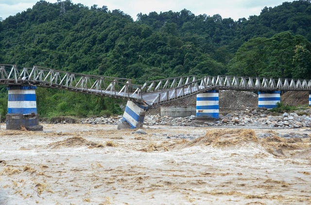 The collapsed Dudhia Iron Bridge over the Balason River after torrential rains in Darjeeling, India, October 5, 2025. REUTERS/Stringer