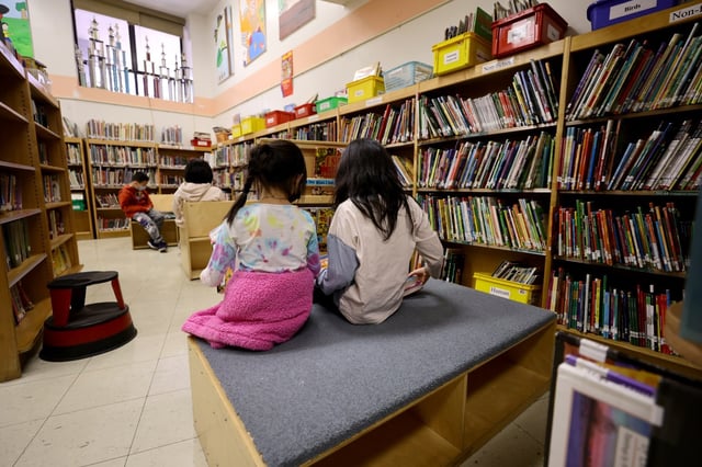 Students in the library receive candy and red envelopes in a cultural celebration of the Lunar New Year at Yung Wing School P.S. 124 on February 02, 2022 in New York City. NYC schools were closed yesterday in observance of what is considered the most important day in the Chinese calendar with the start of the New Year. This event is not only relevant in Asia, but also in other countries where this Chinese tradition is respected and celebrated and is on the table to become the next US Federal Holiday. (Photo by Michael Loccisano/Getty Images)