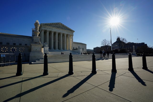 The sun casts shadows as it rises over the U.S. Supreme Court in Washington, U.S., December 20, 2023. REUTERS/Kevin Lamarque/File Photo