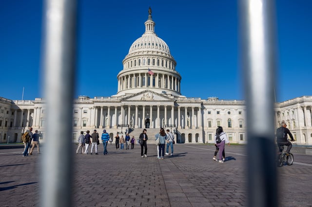 WASHINGTON, DC – OCTOBER 04: Guests walk past the U.S. Capitol on October 04, 2025 in Washington, DC. The government shut down early Wednesday after Congress failed to reach a funding deal. (Photo by Tasos Katopodis/Getty Images)