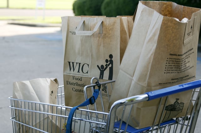 Grocery bags with food from the Special Supplemental Nutrition Program for Women, Infants and Children, or WIC, sit in a shopping cart before being loaded into a vehicle in Jackson, Mississippi, on October. 3, 2013.