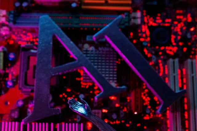 AI (Artificial Intelligence) letters and robot hand are placed on computer motherboard in this illustration created on June 23, 2023. REUTERS/Dado Ruvic/Illustration/File Photo