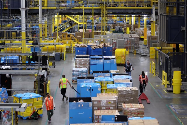Workers move products during Cyber Monday at the Amazon's fulfillment center in Robbinsville, New Jersey, U.S., November 27, 2023. REUTERS/Mike Segar/File Photo
