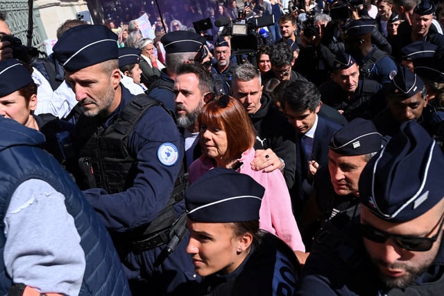 French woman Gisele Pelicot, the victim of a mass rape orchestrated by her then-husband Dominique Pelicot at their home in the southern French town of Mazan, is surrounded by French police as she arrives to attend the first day of the appeal hearing filed by one of the 51 people convicted in her rape trial, at the courthouse in Nimes, France, October 6, 2025. REUTERS/Alexandre Dimou