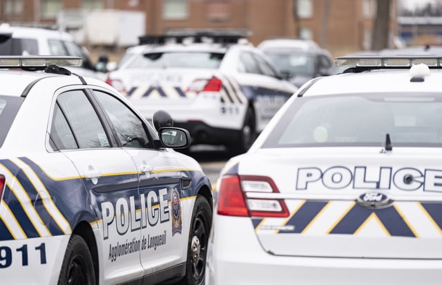 Longueuil police vehicles are parked in Longueuil, Que. Monday, March 4, 2024.