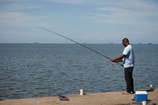 A man fishes in Cocorite, Trinidad and Tobago, Friday, Oct. 3, 2025. (AP Photo/Anselm Gibbs)