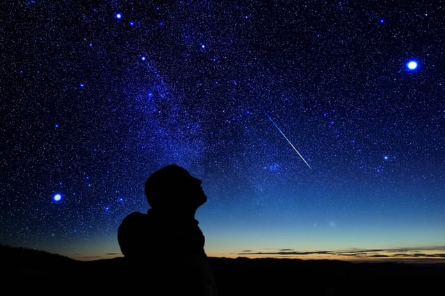 Stock image of a silhouette with stars and a meteor in the background (Picture: Getty Images / m-gucci)