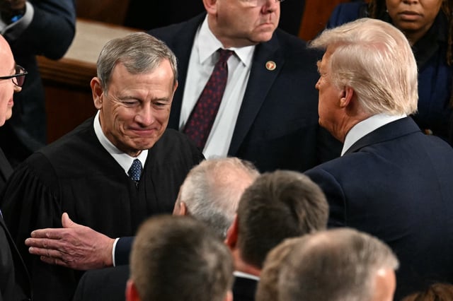 US President Donald Trump (R) greets US Supreme Court Chief Justice John Roberts as Trump to address to a joint session of Congress in the House Chamber of the US Capitol in Washington, DC, on March 4, 2025. (Photo by Jim WATSON / AFP)