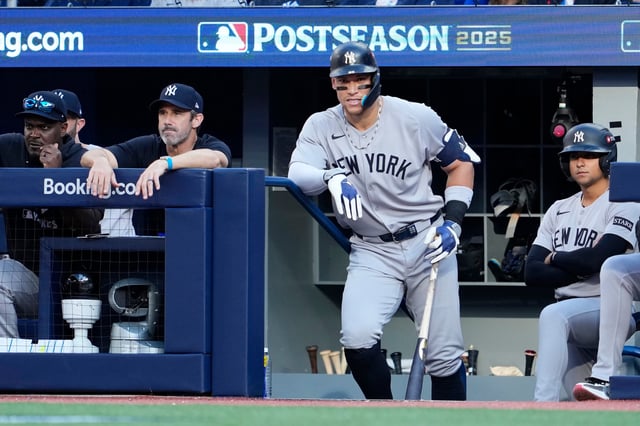 TORONTO, ONTARIO - OCTOBER 05: Aaron Judge #99 of the New York Yankees looks on from the dug out during the third inning in game two of the American League Division Series against the Toronto Blue Jays at Rogers Centre on October 05, 2025 in Toronto, Ontario.  (Photo by Mark Blinch/Getty Images)