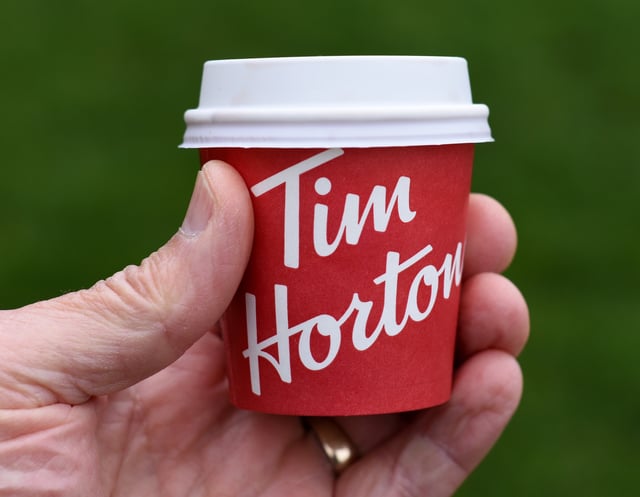 A paper cup of espresso coffee from a Tim Hortons cafe is pictured in View Royal, British Columbia on March 11, 2025. THE CANADIAN PRESS IMAGES/Don Denton