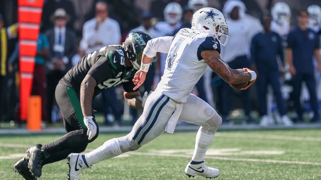 Oct 5, 2025; East Rutherford, New Jersey, USA; Dallas Cowboys quarterback Dak Prescott (4) scrambles against the New York Jets during the second half at MetLife Stadium. Mandatory Credit: Vincent Carchietta-Imagn Images