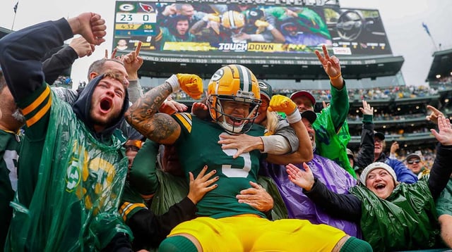 Green Bay Packers wide receiver Christian Watson (9) flexes as he does a “Lambeau Leap” with Packers fans after scoring a touchdown against the Arizona Cardinals on Sunday, October 13, 2024, at Lambeau Field in Green Bay, Wis. The Packers won the game, 34-13 Tork Mason/USA TODAY NETWORK-Wisconsin
