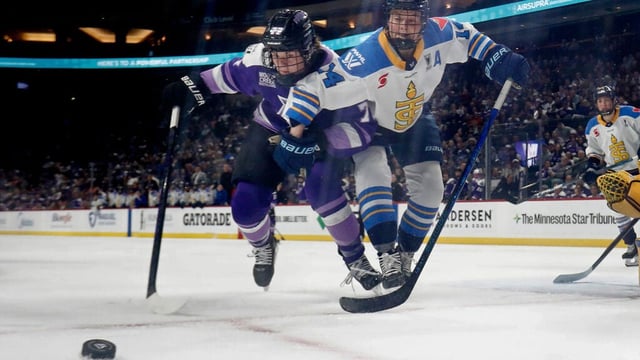 FILE - Minnesota Frost forward Britta Curl-Salemme (77) vies for the puck with Toronto Sceptres forward Natalie Spooner (24) in the second period of a PWHL hockey playoff game May 11, 2025, in St. Paul, Minn. (AP Photo/Bruce Kluckhohn, File)