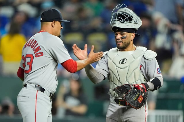 Boston Red Sox relief pitcher Brennan Bernardino, left, celebrates with catcher Carlos Narvaez after their baseball game against the Kansas City Royals, Saturday, May 10, 2025, in Kansas City, Mo. (AP Photo/Charlie Riedel)