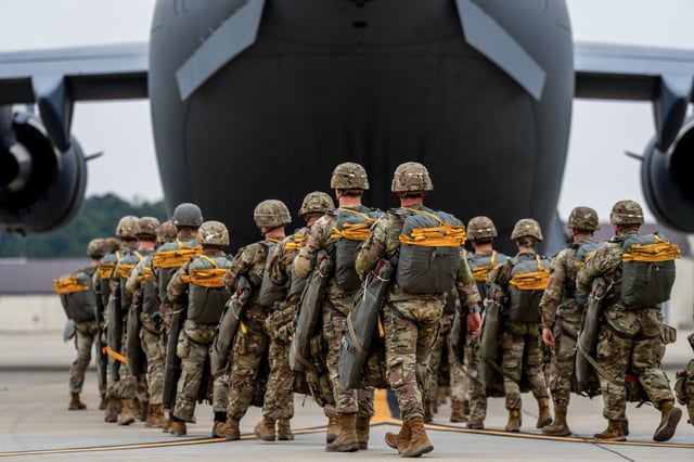 Paratroopers assigned to the 82nd Airborne Division walk to a C-17 Globemaster III before an airborne operation at Fort Bragg, N.C., on March 13, 2025.