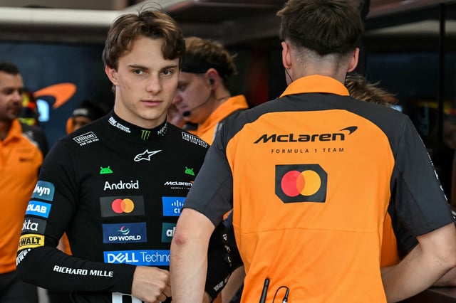 TOPSHOT - McLaren's Australian driver Oscar Piastri (L) looks on before the third practice session ahead of the Formula One Singapore Grand Prix night race at the Marina Bay Street Circuit in Singapore on October 4, 2025. (Photo by MOHD RASFAN / AFP) (Photo by MOHD RASFAN/AFP via Getty Images)