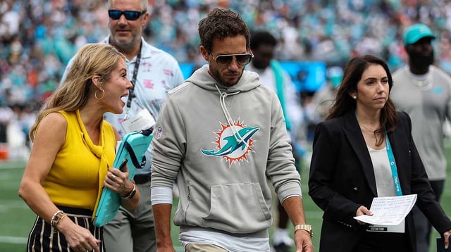 Oct 5, 2025; Charlotte, North Carolina, USA; Miami Dolphins head coach Mike McDaniel talks with a reporter at the end of the first half of the Carolina Panthers and Miami Dolphins game at Bank of America Stadium. Mandatory Credit: Cory Knowlton-Imagn Images