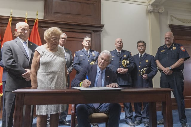 Nassau County Executive Bruce Blakeman signs an executive order.