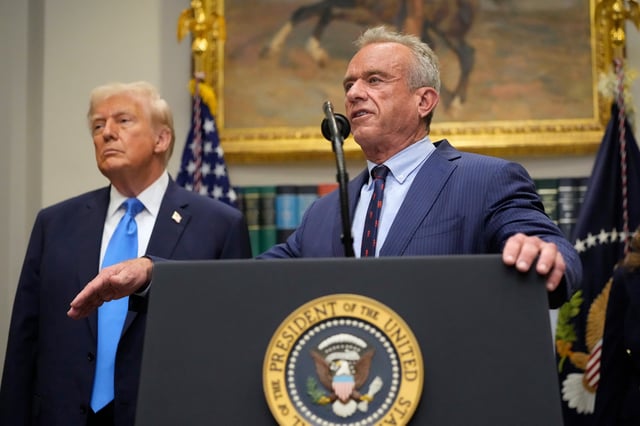 President Donald Trump listens as Health and Human Services Secretary Robert F. Kennedy Jr., speaks in the Roosevelt Room of the White House, Monday, Sept. 22, 2025, in Washington. (AP Photo/Mark Schiefelbein)