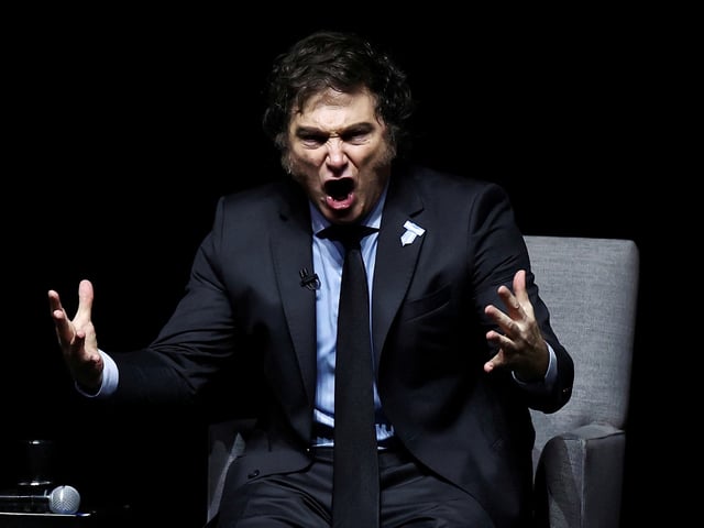 FILE PHOTO: Argentina's President Javier Milei gestures on stage as he presents his new book "Capitalism, Socialism and the Neoclassical Trap", at the Luna Park stadium, in Buenos Aires, Argentina, May 22, 2024. REUTERS/Agustin Marcarian/File Photo