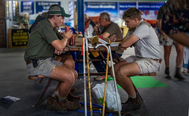 FILE - Farmers sit for lunch at the Nampo agricultural fair, one of the largest in the southern hemisphere, near Bothaville, South Africa, May 15, 2025. (AP Photo/Jerome Delay, File)