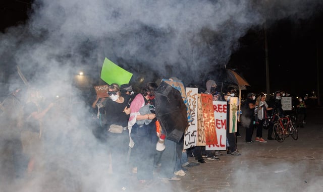 Federal law enforcement officers throw tear gas at protesters outside the Immigration and Customs Enforcement building, Sept. 19, 2025, in Broadview. (Armando L. Sanchez/Chicago Tribune)