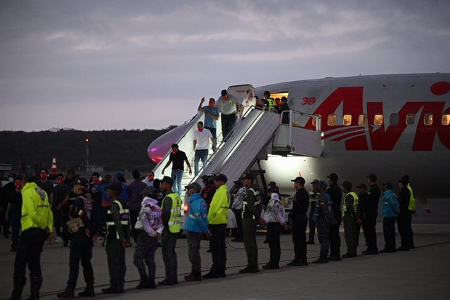 Venezuelan migrants who were jailed in El Salvador get off a plane at Simon Bolivar International Airport in Maiquetia, Venezuela, on July 18, 2025.