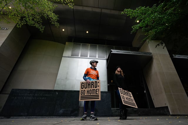 People protest outside a federal courthouse on Oct. 3, 2025, in Portland, Ore.