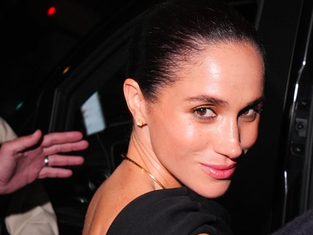 Meghan Markle wearing a black dress