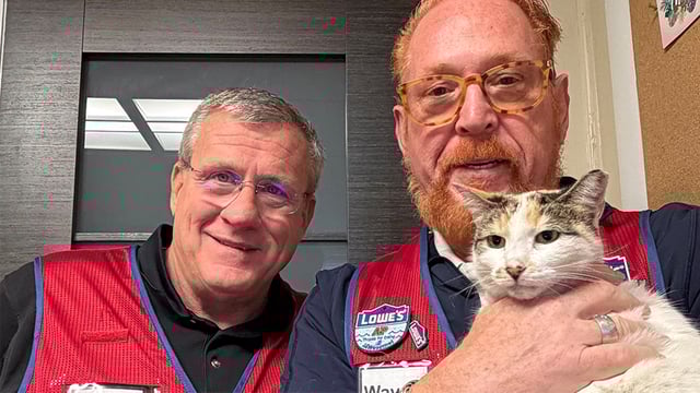 Lowe's employees pose with Francine the cat.