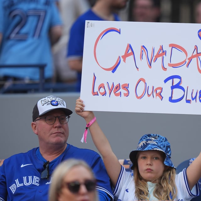 A Toronto Blue Jays fan holds up a sign ahead of the start of the American League Division Series MLB playoff series between the Toronto Blue Jays and the New York Yankees in Toronto on Saturday, October 4, 2025. THE CANADIAN PRESS/Frank Gunn