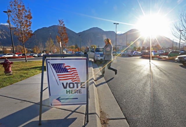 A woman walking to a polling center in Provo, Utah, on November 6, 2018. A Utah state representative has been accused of trying to "steal" an election after his bid to remove Governor Spencer Cox from office failed.