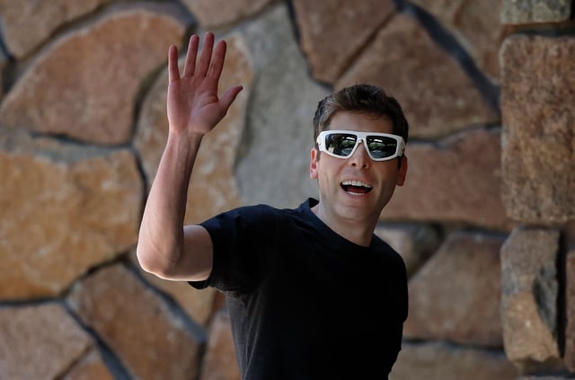 OpenAI CEO Sam Altman waves toward members of the press as he arrives at a conference on July 8, 2025, in Sun Valley, Idaho. 