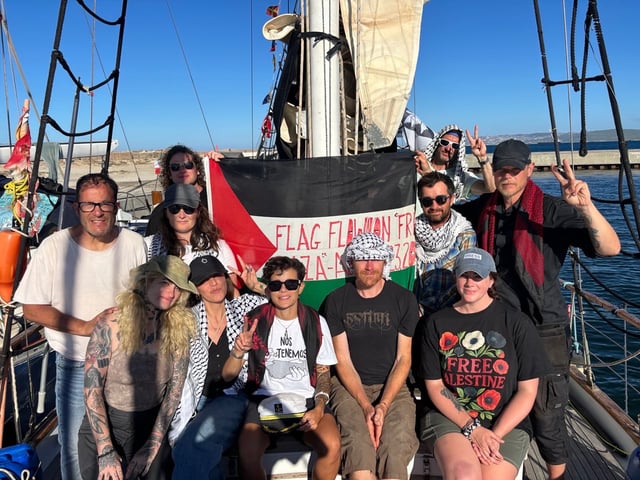 "We were gifted the flag that made it to Gaza on the flotilla in 2008," Logan Hollarsmith, captain of the boat Ohwayla, wrote to his mother Sidney Hollar. Hollarsmith was on board with his crew members. Hollarsmith was wearing sunglasses and standing to the right of the flag. Photo courtesy to Sidney Hollar.