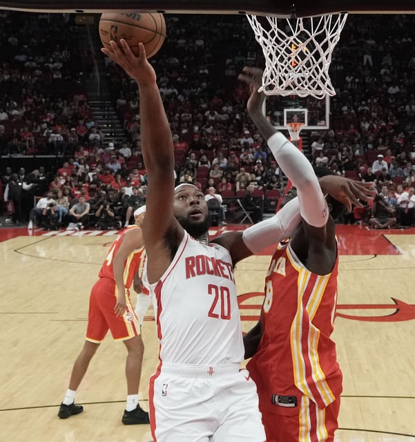 Houston Rockets guard Josh Okogie (20) heads to the basket past Atlanta Hawks defense at the Toyota Center in Houston on Monday, Oct. 6, 2025. Houston Rockets won the game 122-113.