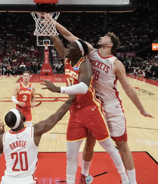 Houston Rockets center Alperen Sengun (28) blocks Atlanta Hawks forward/center Onyeka Okongwu (17) shot in the first half at the Toyota Center in Houston on Monday, Oct. 6, 2025.