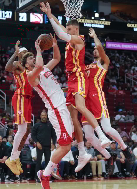 Houston Rockets center Alperen Sengun (28) is fouled as he goes up for a shot against the Atlanta Hawks in the first half of game action at the Toyota Center in Houston on Monday, Oct. 6, 2025.