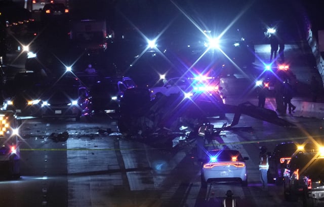 Emergency personnel surround the wreckage of a helicopter that crashed on eastbound Highway 50 in Sacramento, Calif., Monday, Oct. 6, 2025. (AP Photo/Rich Pedroncelli)