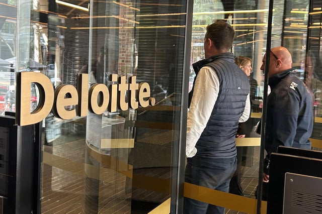People arrive at the offices of Deloitte in Melbourne, Australia, on Tuesday, Oct. 7, 2025. (AP Photo/Rod McGuirk)