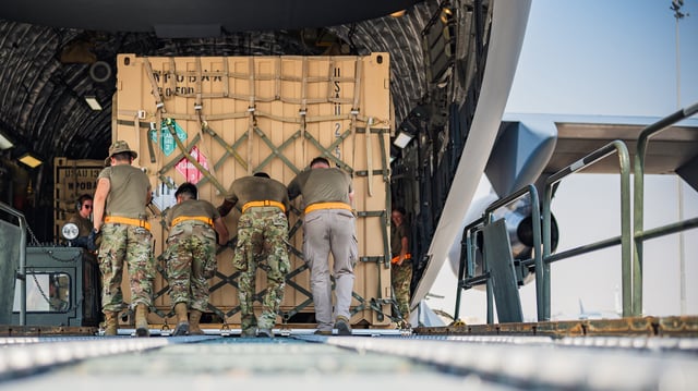 U.S. Air Force personnel of load Terminal High-Altitude Area Defense (THAAD) support equipment being sent to Israel onto a C-17 Globemaster III assigned to the 183rd Expeditionary Airlift Squadron on October 16, 2024.