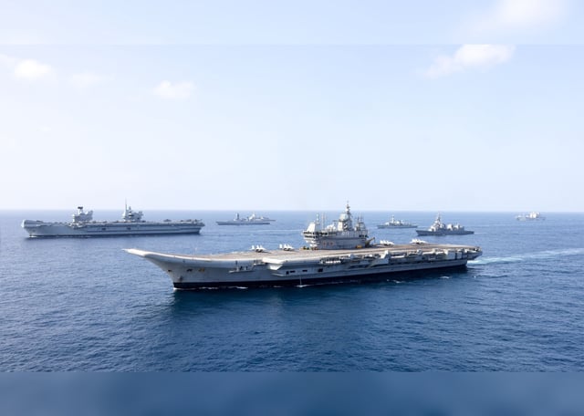 In this October 6, 2025, photo provided by the British military, the British aircraft carrier HMS Prince of Wales, rear, sails in formation with the Indian aircraft carrier INS Vikrant, front, in the western Indian Ocean.