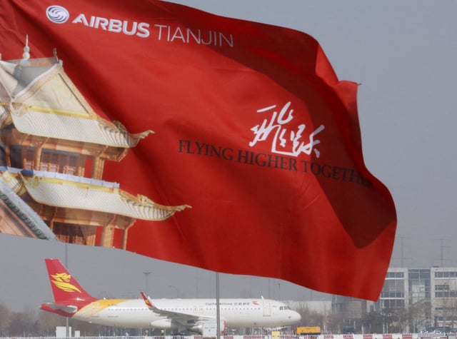 An Airbus Tainjin flag flutters above an Airbus A320 plane near the venue of a ground-breaking ceremony for the Airbus A330 completion and delivery center in Tianjin, China, March 2, 2016.  REUTERS/Kim Kyung-Hoon/File Photo
