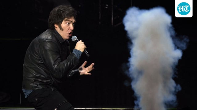 Argentina's President Javier Milei sings during the launch of his new book, The Making of the Miracle, at the Movistar Arena in Buenos Aires on October 6, 2025. (Photo by Luis ROBAYO / AFP)