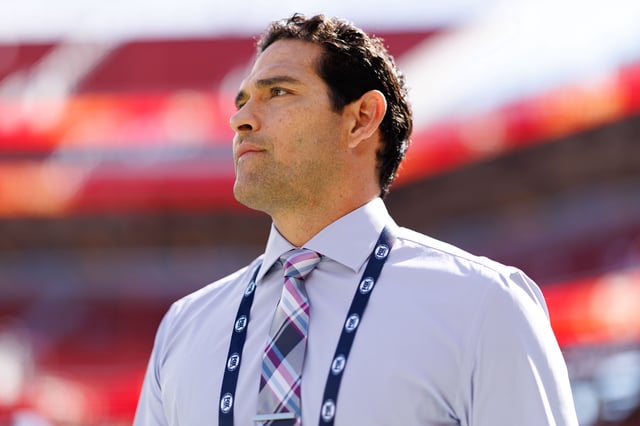 NFL broadcaster Mark Sanchez stands on the field prior to an NFL football game between the Arizona Cardinals and the San Francisco 49ers at Levi's Stadium in Santa Clara, California, on September 21, 2025.