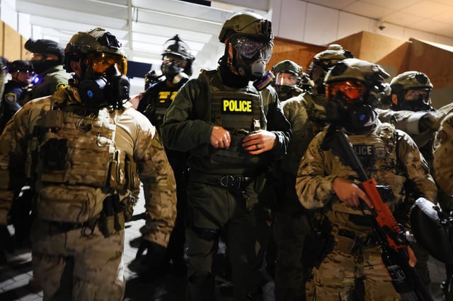 Federal agents, including members of the Department of Homeland Security, Border Patrol, and the police, attempt to keep protesters back outside a downtown U.S. Immigration and Customs Enforcement (ICE) facility on October 05, 2025 in Portland, Oregon.