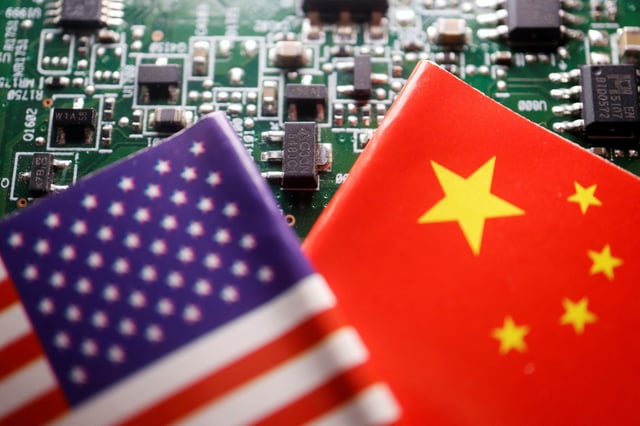 Flags of China and U.S. are displayed on a printed circuit board with semiconductor chips, in this illustration picture taken February 17, 2023. REUTERS/Florence Lo/Illustration