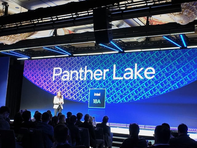 A photograph of Intel's Interim Co-CEO Michelle Johnston Holthaus standing on stage, with a background displaying Panther Lake and Intel 18A