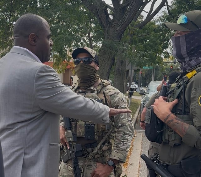 Waukegan Mayor Sam Cuinningham, left, talks to federal agents during the arrest of Dariana Fajardo outside City Hall on Monday. (Photo courtesy of the city of Waukegan)