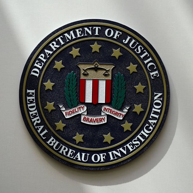 FILE - An FBI seal is seen on a wall on Aug. 10, 2022, in Omaha, Neb.  Violent crime in the US dropped again in 2023, according to FBI statistics that show a continued trend downward after a coronavirus pandemic-era crime spike. The report released Monday shows overall violent crime ticked down an estimated 3% in 2023 from the year before, according to the FBI.  (AP Photo/Charlie Neibergall, File)