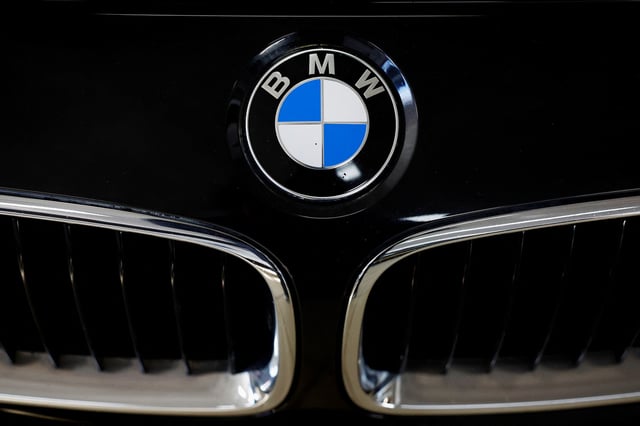 A logo of BMW is seen inside a car dealer in Nijmegen, Netherlands February 26, 2025. REUTERS/Piroschka van de Wouw
